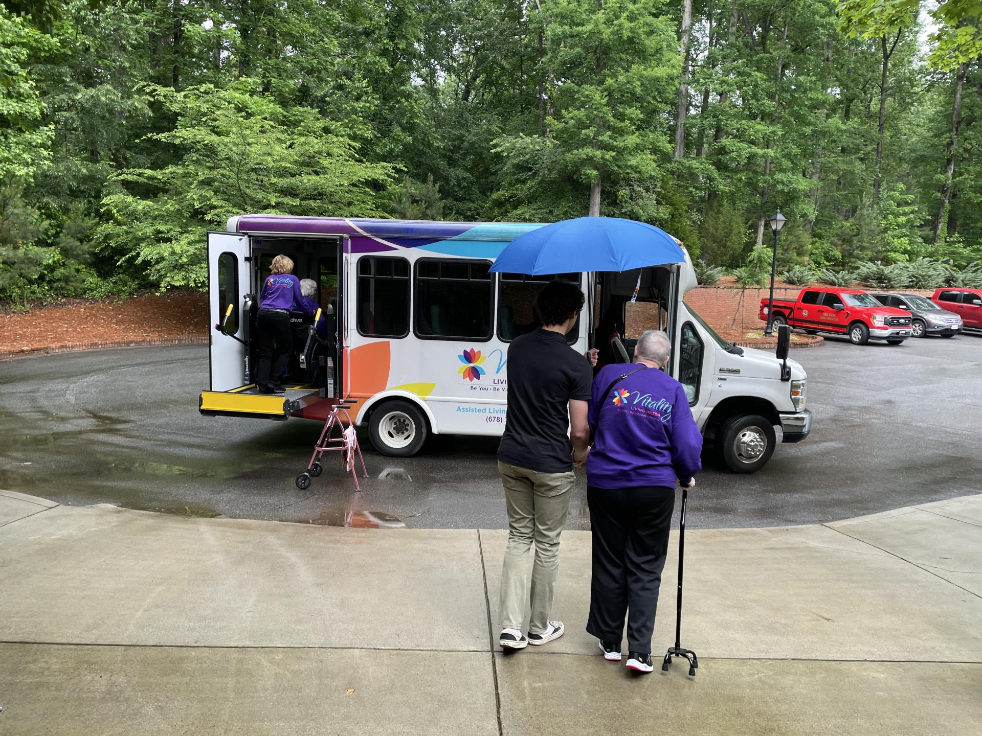 Volunteers assisting load the bus