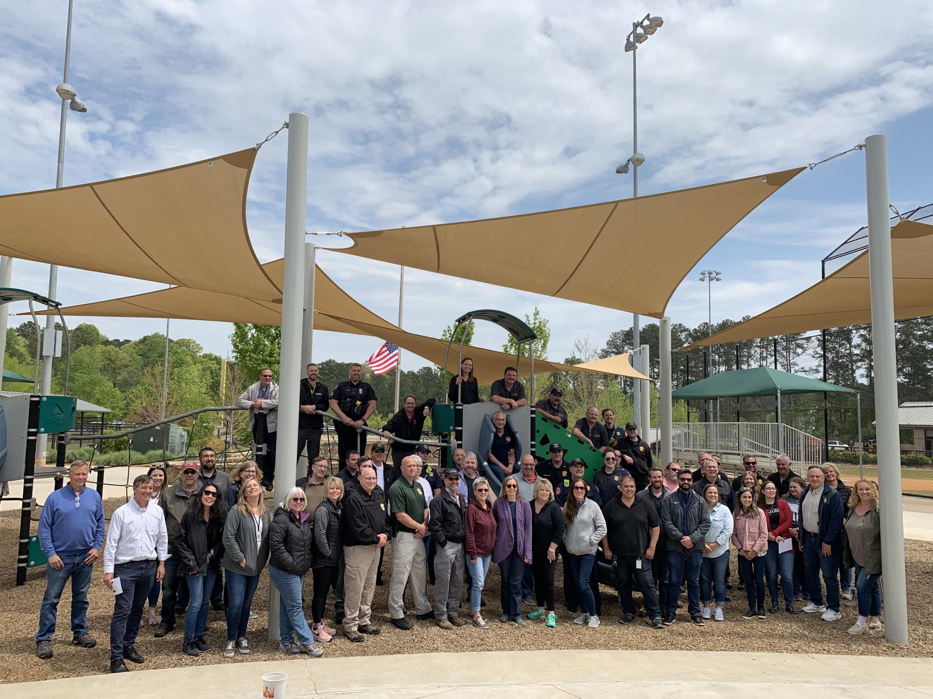 Group photo of Milton City staff in front of playground at Bell Memorial Park