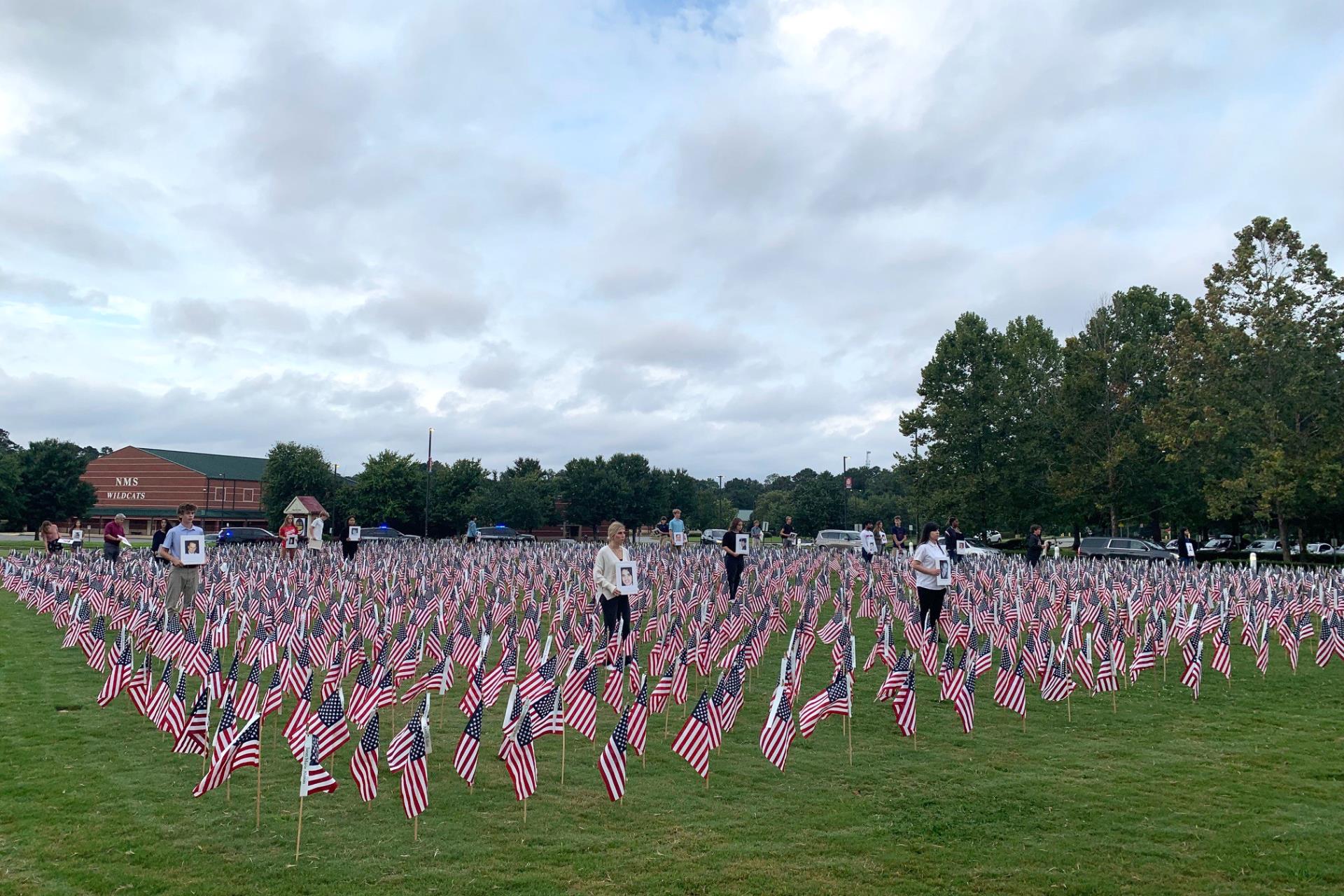 Students on grass flags